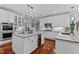 Gourmet kitchen features marble countertops, custom cabinetry, and professional-grade appliances, and a wine refrigerator at 12012 Six Forks Rd, Raleigh, NC 27614