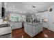 Bright kitchen features custom cabinets, stainless steel appliances, and a large center island with seating at 12012 Six Forks Rd, Raleigh, NC 27614