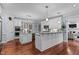 Spacious kitchen features white cabinetry, stainless steel appliances, a large island, and eat-in breakfast area at 12012 Six Forks Rd, Raleigh, NC 27614