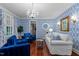 Stylish living room featuring a unique blue and white patterned wallpaper, bright white trim and cherry hardwood flooring at 12012 Six Forks Rd, Raleigh, NC 27614