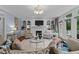 Elegant living room featuring a fireplace, custom built-ins, plush seating, and access to the outdoor living area at 12012 Six Forks Rd, Raleigh, NC 27614