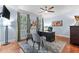 Well-lit home office with hardwood floors, a ceiling fan, and neutral-toned walls at 12012 Six Forks Rd, Raleigh, NC 27614