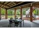Inviting outdoor patio with brick pillars, modern furniture, and view of pool at 12012 Six Forks Rd, Raleigh, NC 27614
