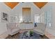 Bright sitting room features vaulted wood ceiling, comfortable seating, natural light, and a functional wet bar at 12012 Six Forks Rd, Raleigh, NC 27614