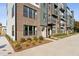 Charming townhome complex with brick exterior, balconies, and well-maintained lawns at 1218 Coach Station Alley # 101, Raleigh, NC 27601