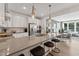 Open-concept kitchen with stainless steel appliances and counter seating adjoining a dining area at 1218 Coach Station Alley # 101, Raleigh, NC 27601