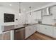 Contemporary kitchen featuring stainless steel appliances, white cabinets, and hardwood floors at 1218 Coach Station Alley # 101, Raleigh, NC 27601