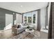 Bright living room with modern furnishings, hardwood floors, and large windows at 1218 Coach Station Alley # 101, Raleigh, NC 27601