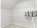 Organized walk-in closet featuring wire shelving and ample space for storage solutions with carpeted floors at 1218 Coach Station Alley # 101, Raleigh, NC 27601