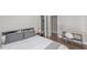 Serene bedroom featuring hardwood floors, a gray headboard, and a minimalist aesthetic for rest and relaxation at 1301 Clarendon St, Durham, NC 27705