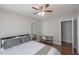 Spacious bedroom with hardwood floors, a ceiling fan, and a desk area, providing a comfortable and versatile living space at 1301 Clarendon St, Durham, NC 27705
