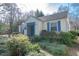Quaint home featuring blue trim and shutters and mature landscaping, creating a welcoming curb appeal at 1301 Clarendon St, Durham, NC 27705