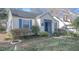 A charming house with blue trim and shutters, set in a yard with mature bushes at 1301 Clarendon St, Durham, NC 27705