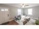Bright living room with hardwood floors, a gray sofa, and natural light from large windows at 1301 Clarendon St, Durham, NC 27705