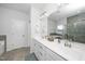 Bathroom featuring dual sinks, a large mirror, and an enclosed shower at 1516 Barn Door Dr, Apex, NC 27502