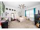 A bright bedroom with a ceiling fan, a tapestry, and an array of eclectic decorations at 1516 Barn Door Dr, Apex, NC 27502