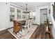 Dining room featuring large windows, a modern chandelier, and seating for six at 1516 Barn Door Dr, Apex, NC 27502