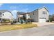 Back exterior view of the home, showcasing the backyard fire pit area and the garage at 1516 Barn Door Dr, Apex, NC 27502