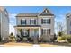 Charming two-story home featuring a welcoming front porch and landscaped garden at 1516 Barn Door Dr, Apex, NC 27502
