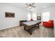 Game room with pool table, seating, and natural light at 1516 Barn Door Dr, Apex, NC 27502