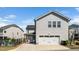 Two-car garage with a basketball hoop adjacent to the fenced backyard of a gray home at 1516 Barn Door Dr, Apex, NC 27502