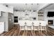 Modern kitchen featuring white cabinets, stainless steel appliances, and a spacious island at 1516 Barn Door Dr, Apex, NC 27502