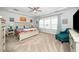 A spacious bedroom features a ceiling fan, sitting area, and a neutral color palette at 1516 Barn Door Dr, Apex, NC 27502