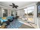 Relax on the screened porch with a comfortable seating area and decorative ceiling fan at 1516 Barn Door Dr, Apex, NC 27502