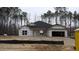 Unfinished exterior of a single-story home with a dark roof and an attached two-car garage at 1681 Pecan Drive # 22, Nashville, NC 27856