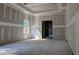 Unfinished living room with tray ceilings, a window, and unfinished floors at 1791 Pecan Drive # 22, Nashville, NC 27856