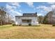Back exterior of a two story home with a screened-in back porch and large backyard at 205 Fox Hollow Dr, Clayton, NC 27527