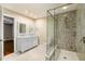 Bright primary bathroom featuring double sink vanity, marble floors and frameless glass shower at 205 Fox Hollow Dr, Clayton, NC 27527