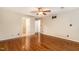 Open bedroom featuring hardwood floors, neutral paint, a ceiling fan, and interior doors at 205 Fox Hollow Dr, Clayton, NC 27527