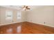 Spacious bedroom with hardwood floors, neutral paint, ceiling fan, and light-filled windows at 205 Fox Hollow Dr, Clayton, NC 27527