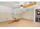 Large bonus room with beige carpet, ceiling fan, partially painted, and lots of potential at 205 Fox Hollow Dr, Clayton, NC 27527
