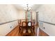 Formal dining room with hardwood floors, floral wallpaper, and an elegant chandelier at 205 Fox Hollow Dr, Clayton, NC 27527