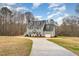 Charming two-story home with blue shutters, gray siding, well-maintained lawn, and attached garage at 205 Fox Hollow Dr, Clayton, NC 27527