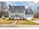 Charming two-story home with blue shutters, gray siding, well-maintained lawn, and attached garage at 205 Fox Hollow Dr, Clayton, NC 27527