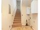 Staircase with carpet, a hand rail and overhead storage cabinets at 205 Fox Hollow Dr, Clayton, NC 27527