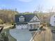 Picturesque aerial view of a home with a two-car garage, manicured lawn and inviting front porch situated on a spacious lot at 2244 Plowridge Rd, Fuquay Varina, NC 27526