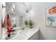 Well lit bathroom features a white vanity, framed mirror, and floral decor at 2244 Plowridge Rd, Fuquay Varina, NC 27526
