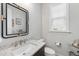 Elegant powder room with granite counters, modern fixtures, and decorative mirror at 2244 Plowridge Rd, Fuquay Varina, NC 27526
