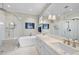 Bright bathroom with double vanity, soaking tub, and glass-enclosed shower at 2244 Plowridge Rd, Fuquay Varina, NC 27526