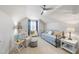 Cozy bedroom features a daybed, seating area, ceiling fan, and ample natural light at 2244 Plowridge Rd, Fuquay Varina, NC 27526