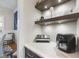 Convenient butler's pantry with counter space, open shelving, and modern appliances at 2244 Plowridge Rd, Fuquay Varina, NC 27526
