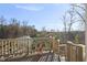 Enjoy the wooded view from this deck with wooden railings and composite decking at 2244 Plowridge Rd, Fuquay Varina, NC 27526