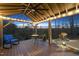 Inviting covered deck featuring a seating area and views of the landscaped yard at 2244 Plowridge Rd, Fuquay Varina, NC 27526