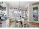 Light filled dining room features a classic chandelier, wood floors, and shiplap wall detail at 2244 Plowridge Rd, Fuquay Varina, NC 27526
