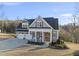 Charming two-story home with a welcoming front porch, two-car garage, and beautifully maintained landscaping at 2244 Plowridge Rd, Fuquay Varina, NC 27526