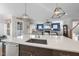 Open-concept kitchen island with quartz countertops and stainless steel appliances at 2244 Plowridge Rd, Fuquay Varina, NC 27526